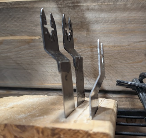 Some reciprocating tool blades in a piece of wood acting as a holder